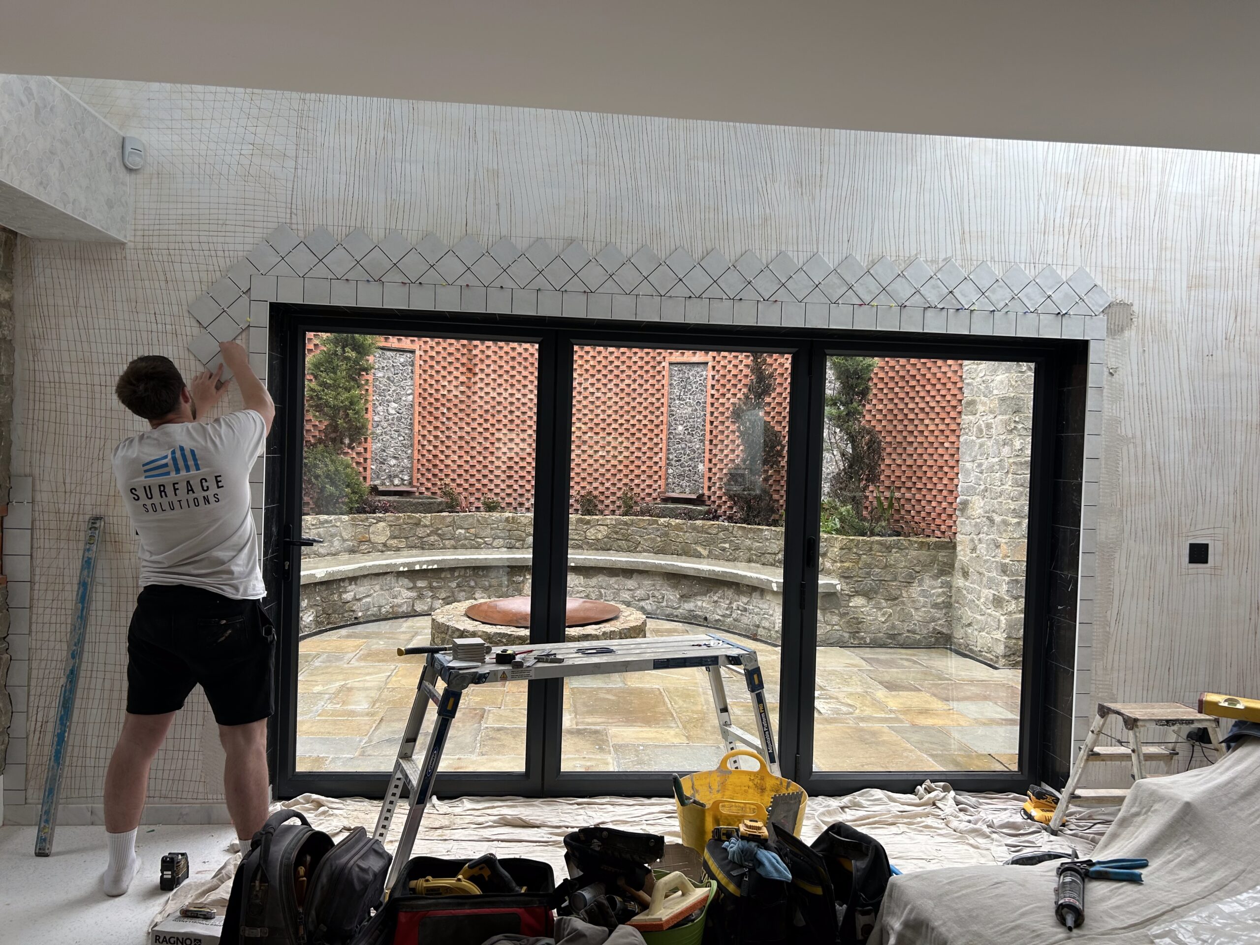 IMG_7370 An image of Surface Solutions employee carrying out tiling work